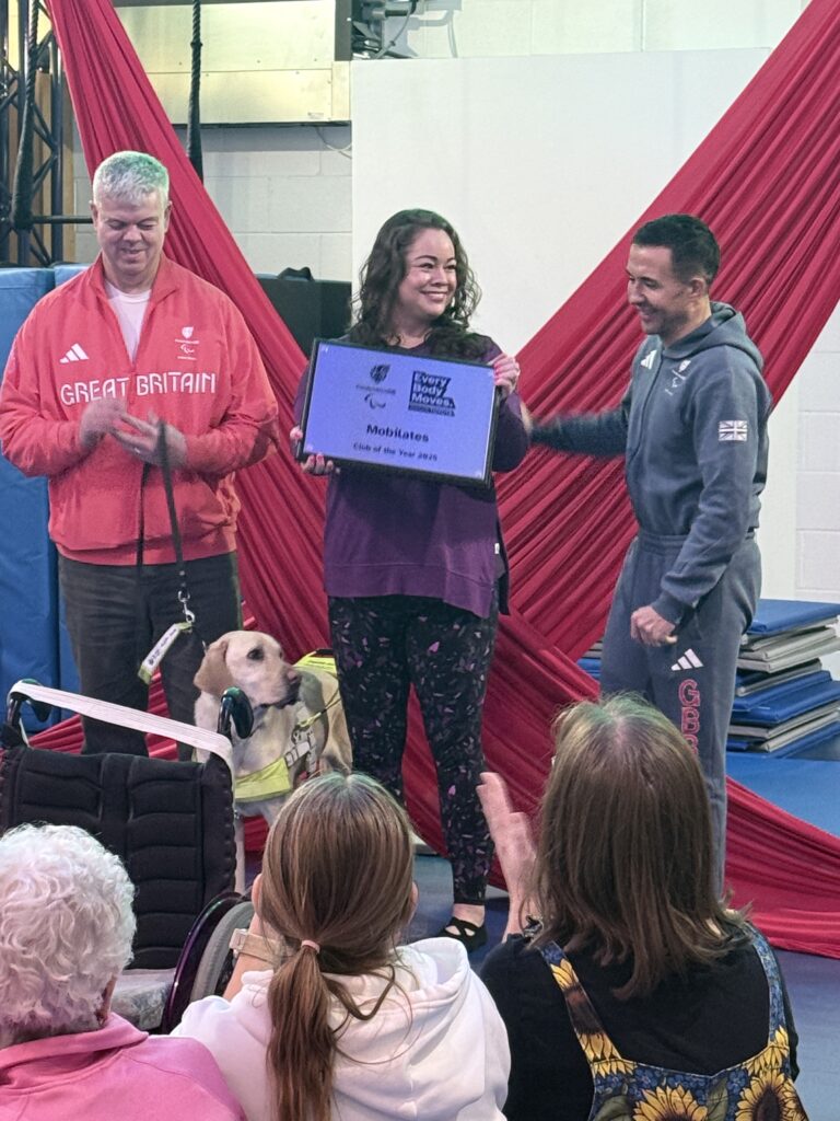 Leanne standing in between Will and Dave being presented with the Everybody Moves Club of The Year Award